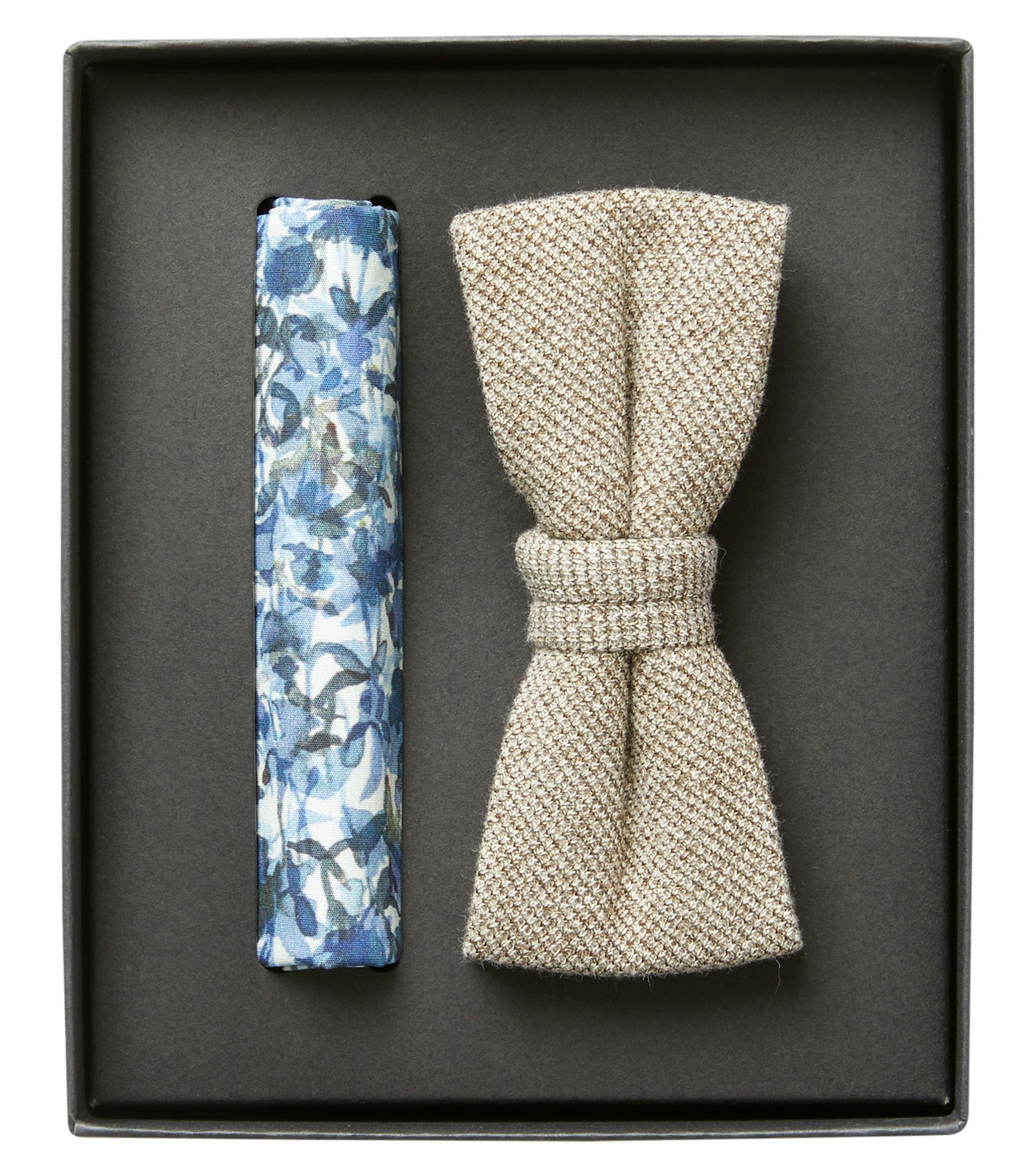 Das Model trägt eine Fliege im gemustert Muster in der Farbe Weißbeige