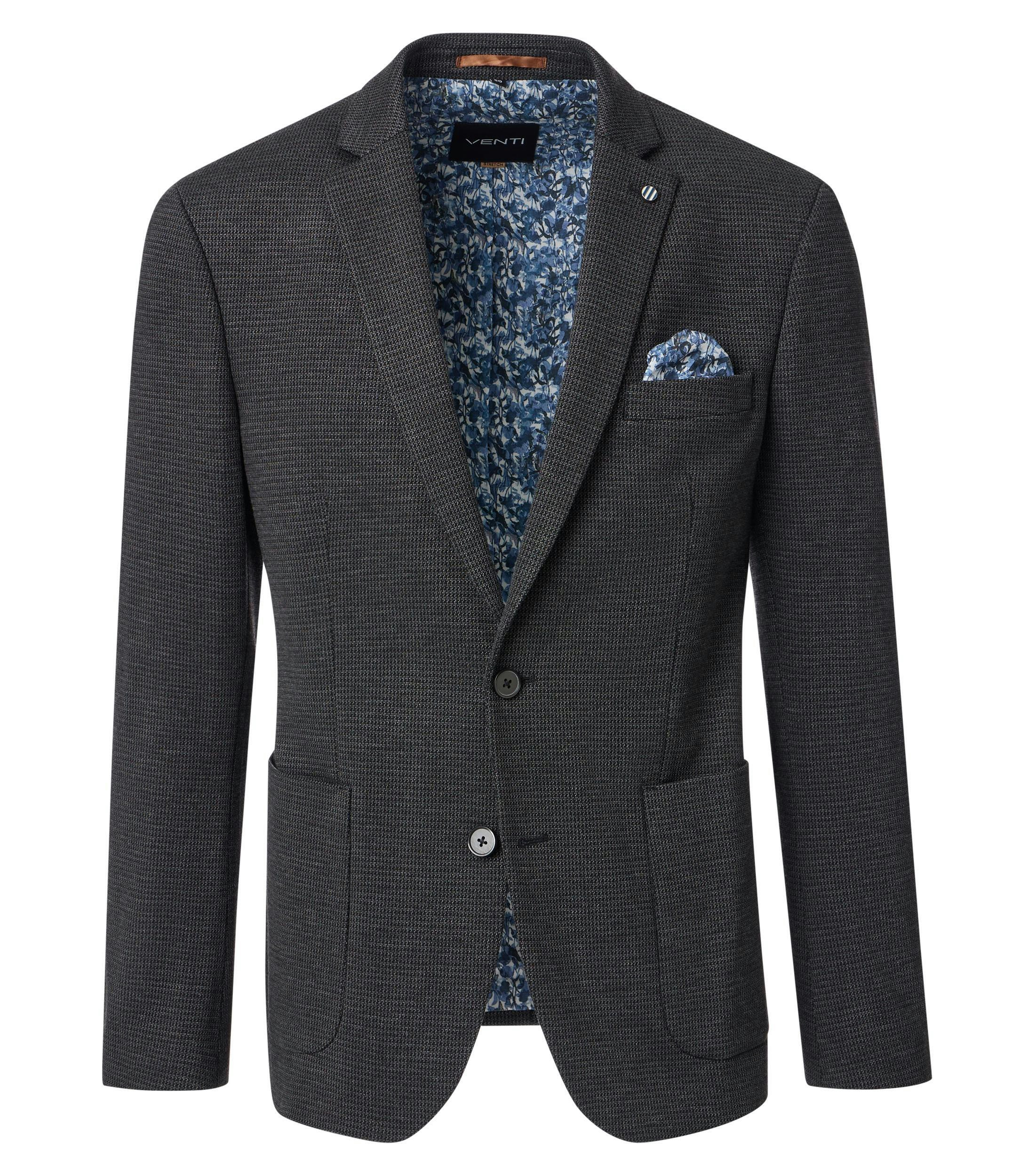 Das Model trägt ein Sakko im uni Muster in der Farbe Dunkelgrün