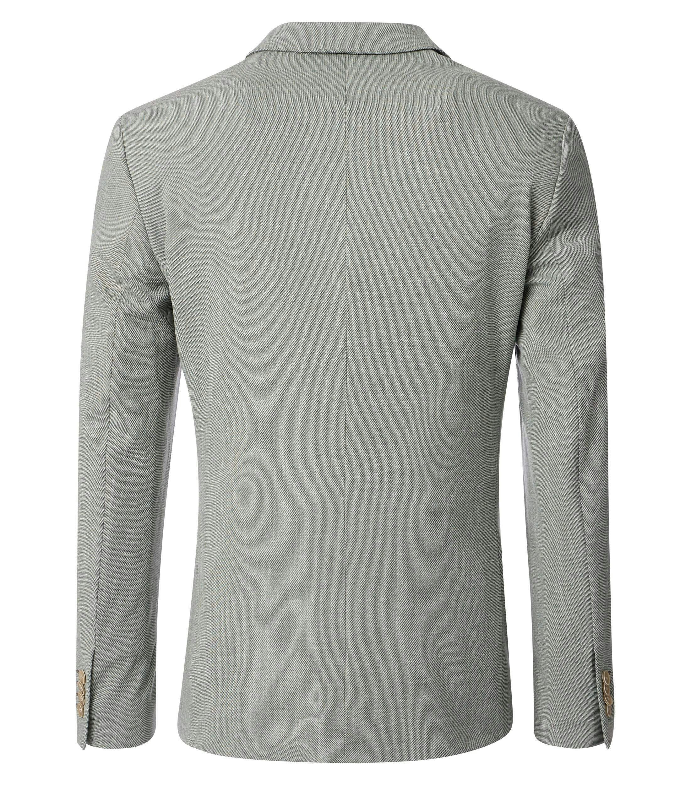 Das Model trägt ein Sakko im uni Muster in der Farbe Grün