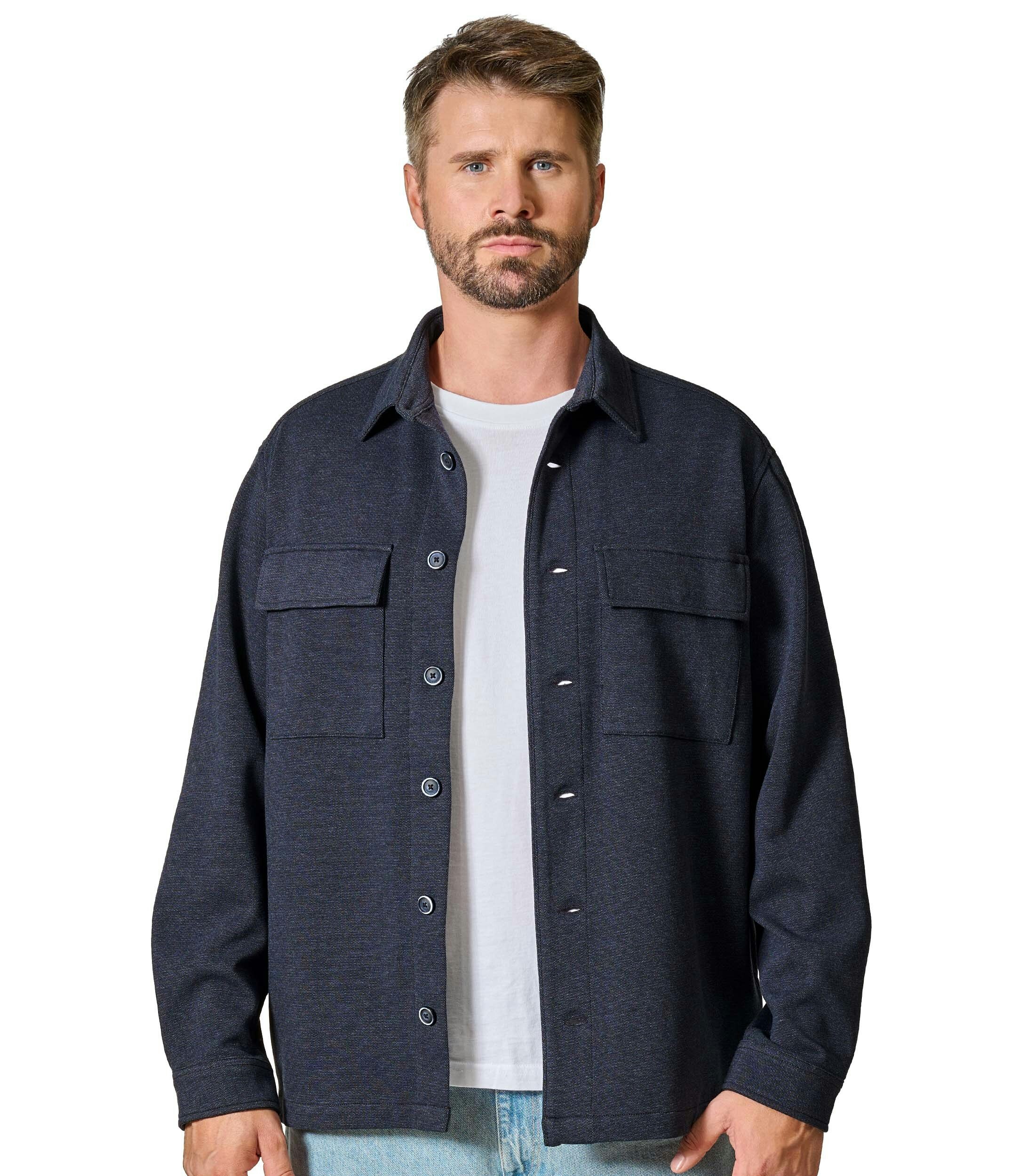 Das Model trägt ein Businesshemd im uni Muster in der Farbe Blau